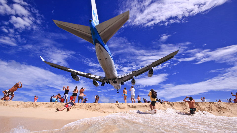 St Maarten / St Martin one of the most famous tourism sites - plane landing over Maho Beach and tourists