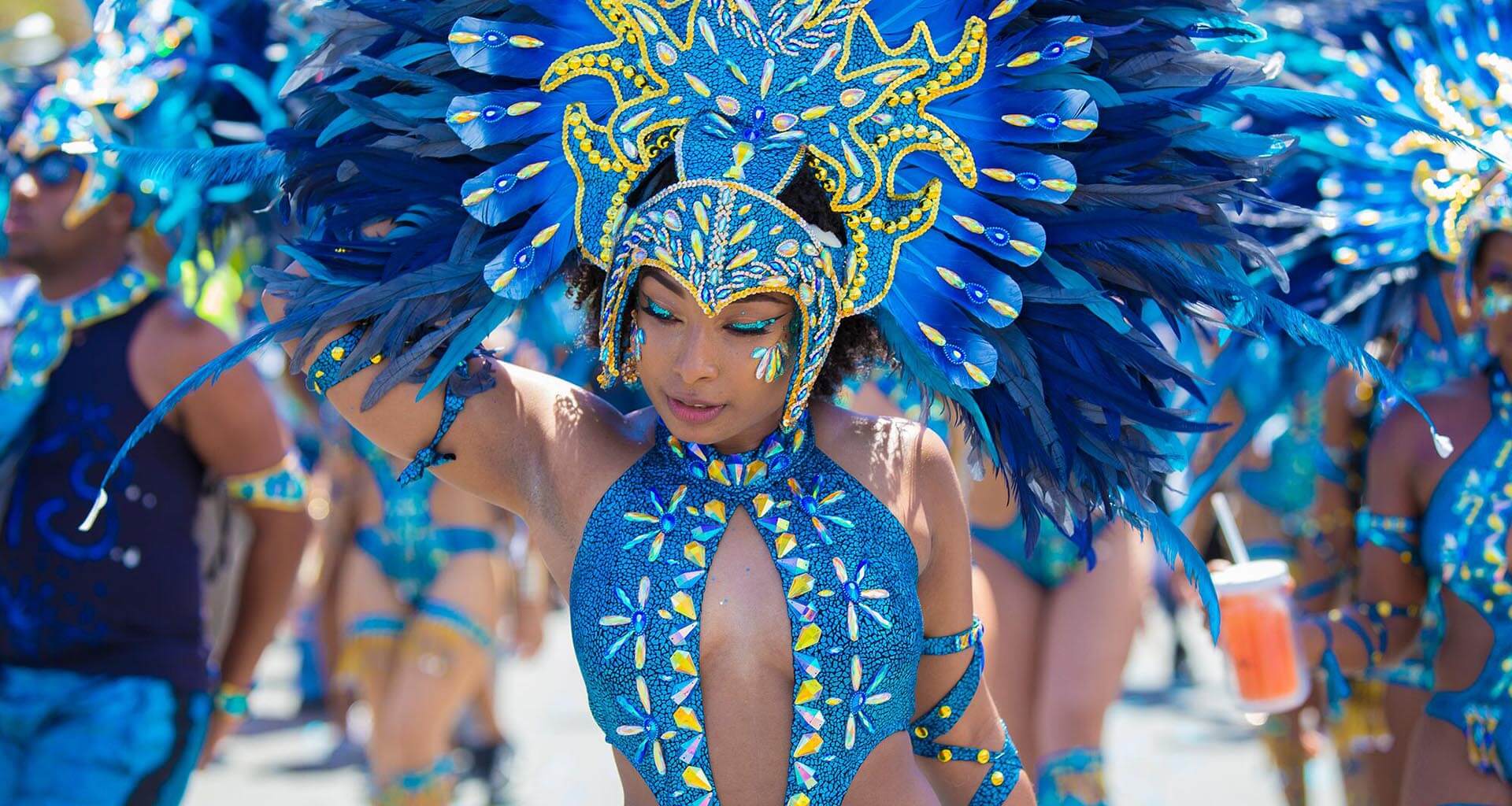 Carnival SXM, Carnival St Maarten, woman dressed in typical Caribbean Carnival clothes with blue feathers