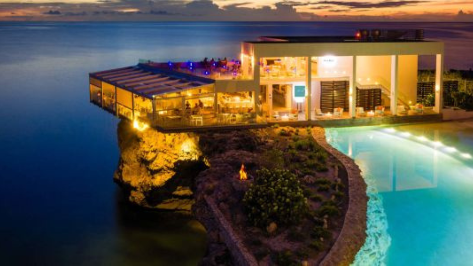 Sonesta Ocean Point at night with pool in the front at the sea