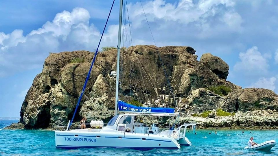 Catamaran and dinghy in front of Creole Rock St Martin