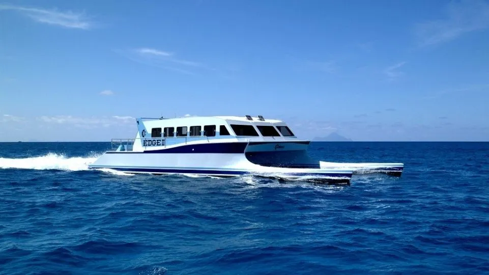 A white catamaran driving in the sea from de company EDGE