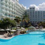 Sonesta Resort pool and hotel in the background with palmtrees all around