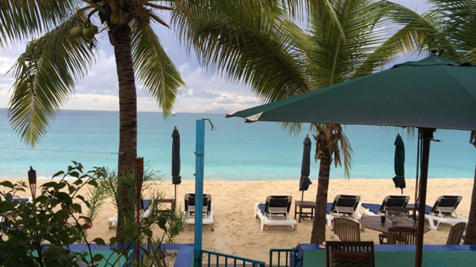 Beach chairs, palm trees and view on Simpson Bay from Azure Hotel