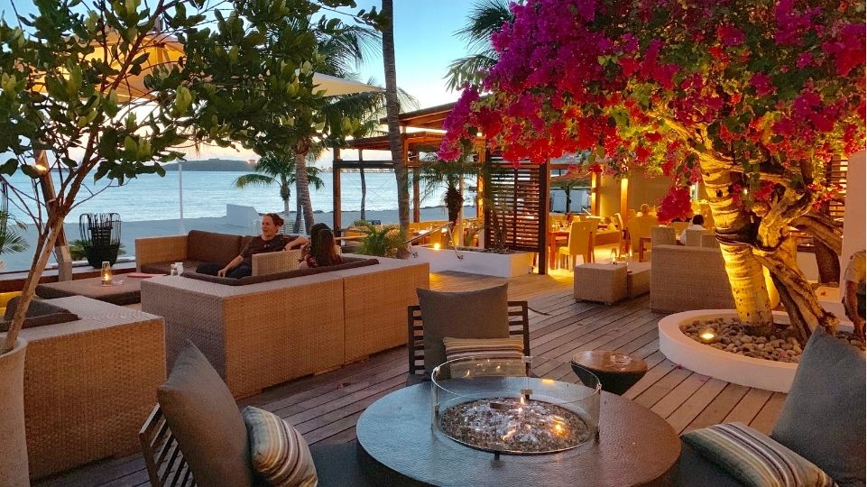ocean lounge bar chairs and tables at nighttime