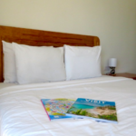 Seaview beach hotel room with magazines on the bed