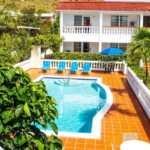 Pool and orange tiled terrace at central square of L’ Esperance Hotel