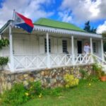 St Maarten national flag outside of Plantation House Pasture Piece Bed & Breakfast