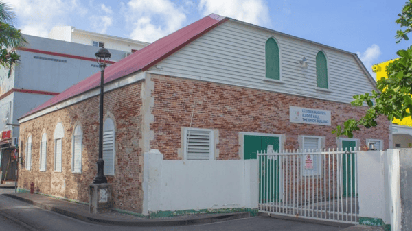 Brick Illidge school building with fence in front
