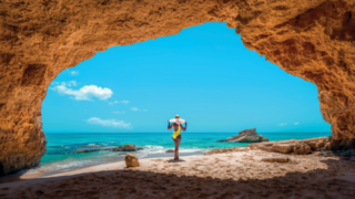 Lady in a cave under the pink cliffs of Cupecoy St Maarten