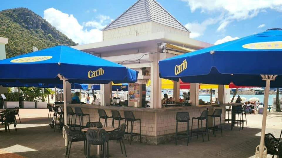 St Rose Bar & Cafe welcoming guests with umbrellas and chairs outside by the Boardwalk in Philipsburg on St Maarten / St Martin