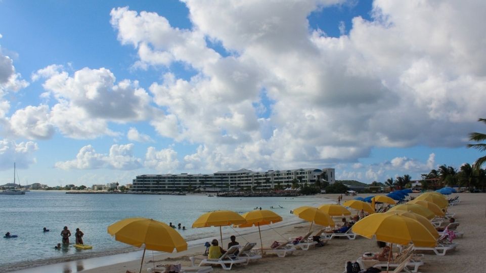 Kim Sha Beach in Simpson Bay being filled with tourists, beach chairs and umbrellas during a cloudy day