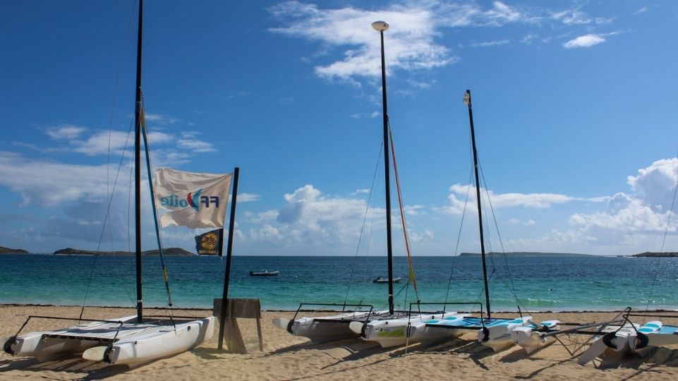 Catamaran rentals at Orient Bay beach with clouded St Martin weather