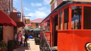 in the front you see trams from Amsterdam , behind the trams trams is the bar from AMAsterdam with people in the front. Located in Frontstreet, the Philipsburg area of St Maarten