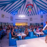 A lady dancing in a blue dress in restaurant Toppers in Simpson Bay