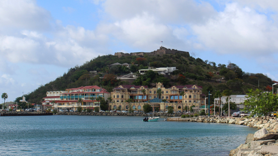 View ofView of the West Indies Shopping Mall on Marigot Waterfront with Fort St Louis in background the West Indies Shopping Mall on Marigot Waterfront with Fort St Louis in background