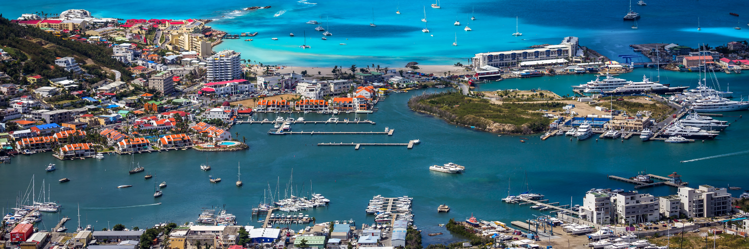 Aerial photo of Simpson Bay Lagoon where one could rent a yacht, visit a boat rental or tour agency to find the best way how to get around the island of St Maarten / St Martin