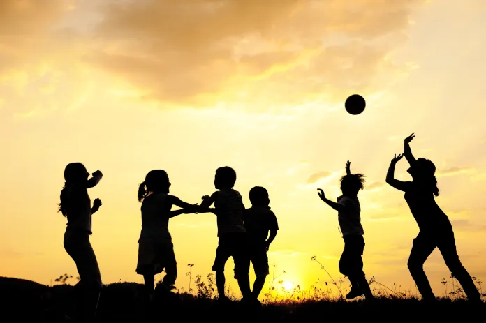 Group of happy children playing ball