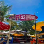 In front of a sign by restaurant Buccaneer in Simpson Bay