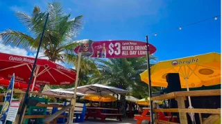 In front of a sign by restaurant Buccaneer in Simpson Bay