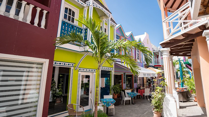 View of St Maarten Old Street with colorful houses and palm trees