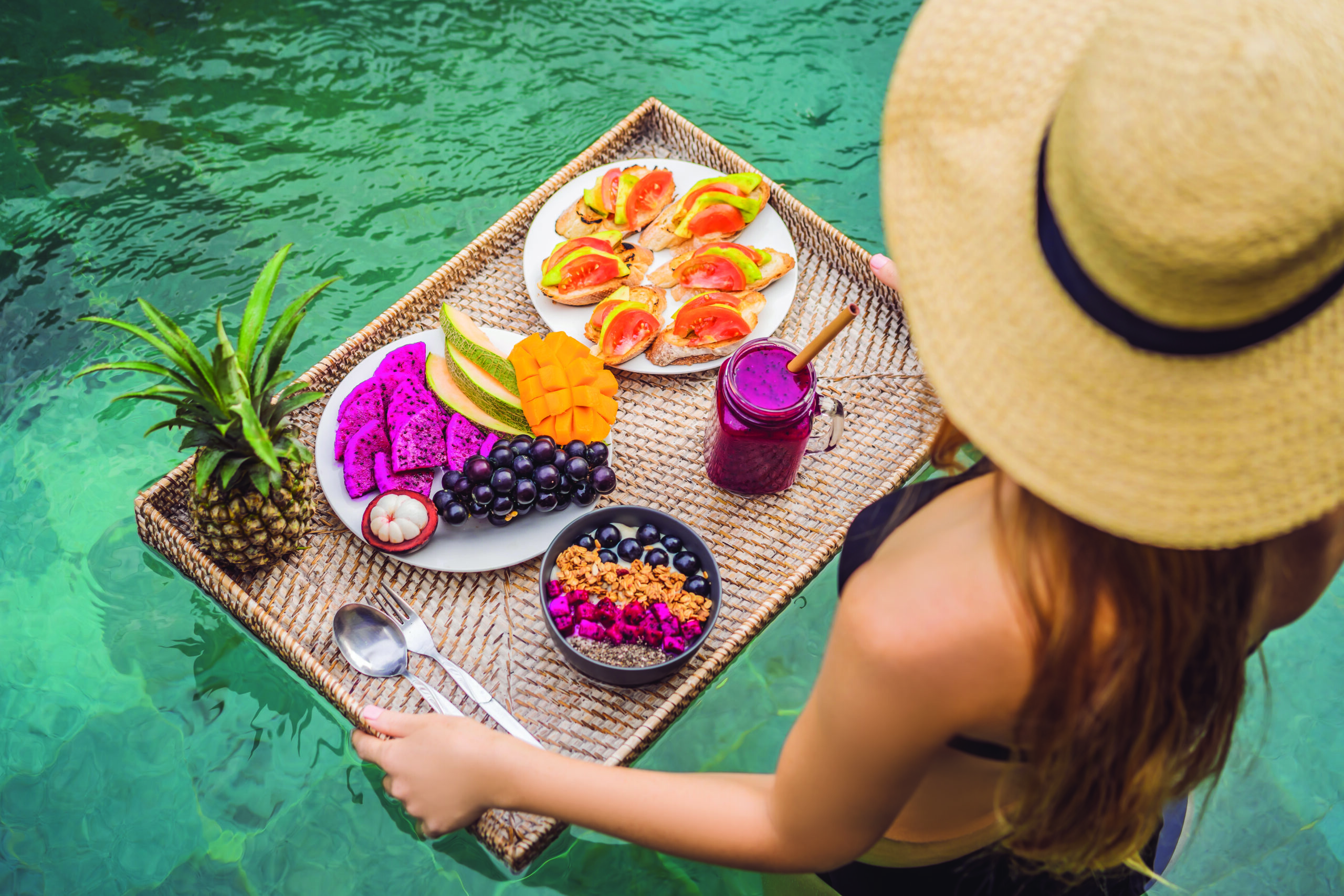 Self care with breakfast tray floating in the pool.