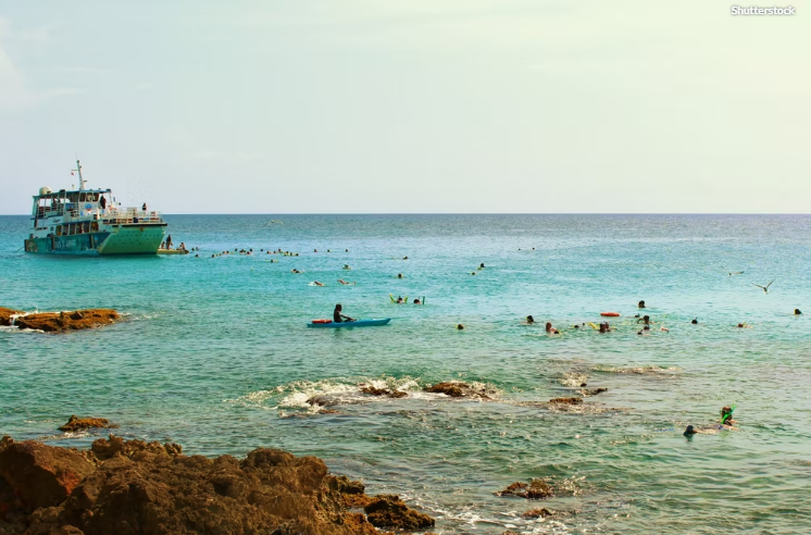 Tourists snorkeling in the Caribbean Sea on St Maarten, St Martin, things to do in the water St Maarten