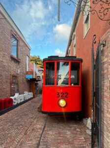 red tram in street at amasterdam bar 