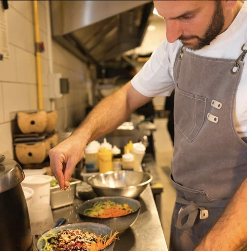 The chef cooking a dish in restaurant Mr. Chow