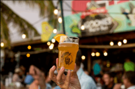 A man holding a beer in de middle with at Pelikaan Brewery
