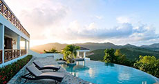 St Maarten villa rental with lush green hills in background at sunny weather 