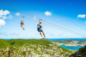 Two persons ziplining in the Rainforest Adventure Park