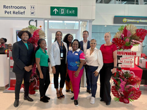 Group posing at the Princess Juliana Airport regarding the new flight to neighboaring islands