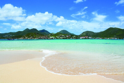 sand and beach with hills in the background in st. maarten