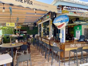 the bar' the pier' in st maarten with stools and creations hanging on the bamboo wall