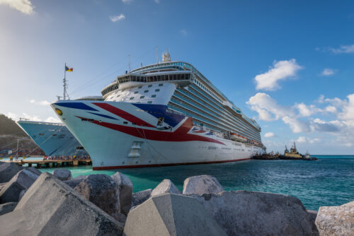 cruise boat of britannia with a british flag on it in the harbour of philipsburg