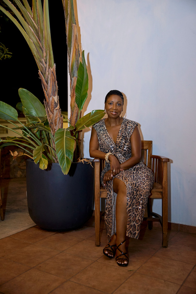 Judy King sitting by a palm