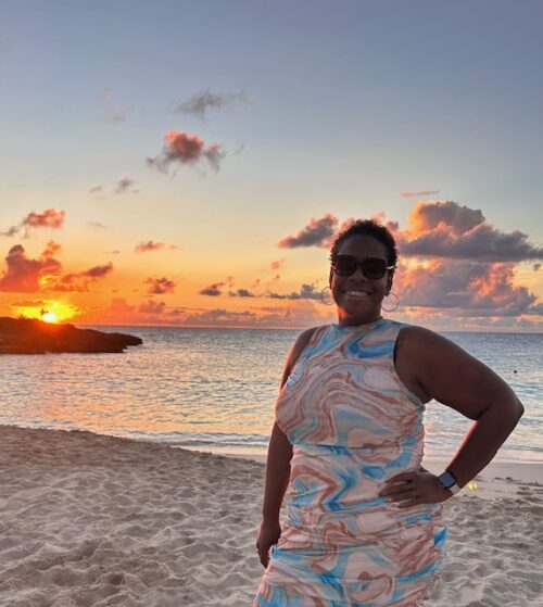 krystal wanga at the beach with a sunset in the background