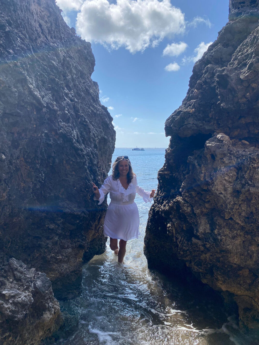 sabine berger between 2 rocks in sea in st maarten