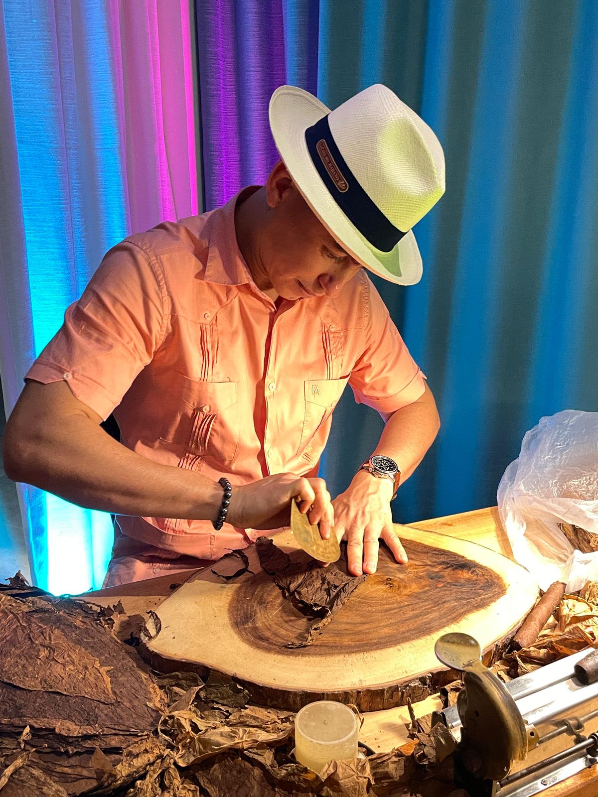 Master roller displaying how to roll your own cigar