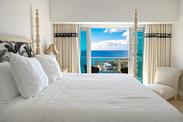 Curtains and window in luxury villa room overlooking Caribbean