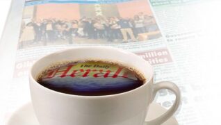 Cup of coffee and a newspaper from The Daily Herald