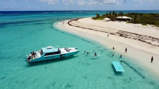 Catamaran anchored next to a beach during Anguilla Tour by Boomerang Boat Charters