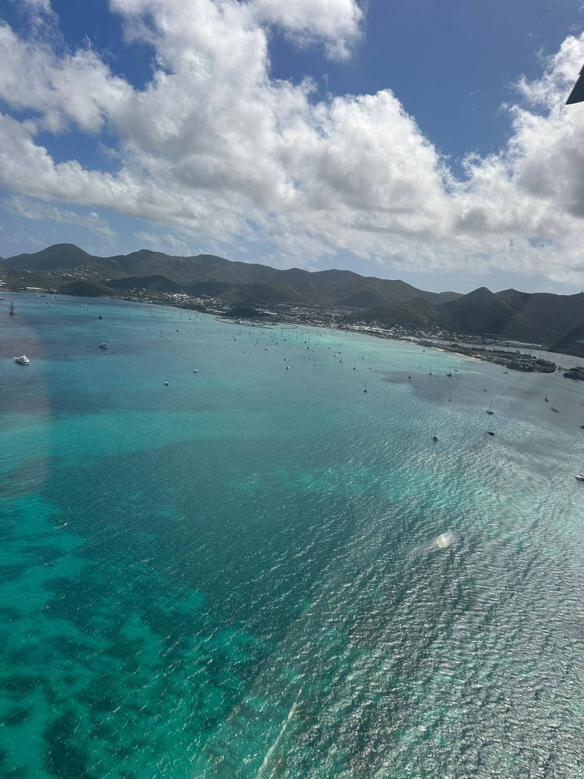 Helicopter view of Marigot and surroundings with blue sea and sunrays