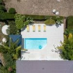 Blue Sailing Pool villa with swimmingpool and yellow chairs 