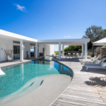 Villa pool with blue water and beds