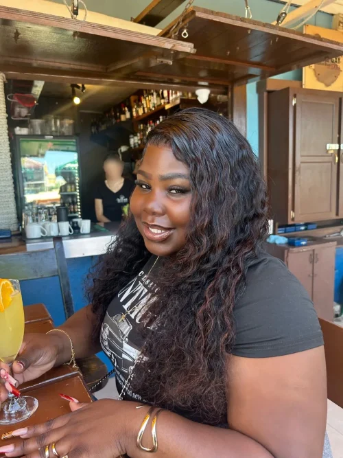 Roneice Williamson from Salty Seafood at a restaurant with a drink