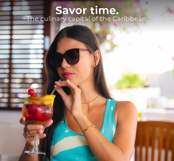 Woman drinking from cocktail at a restaurant on St Maarten
