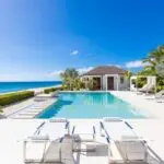 Villa Turle Nest with swimming pool white chairs and a shed 