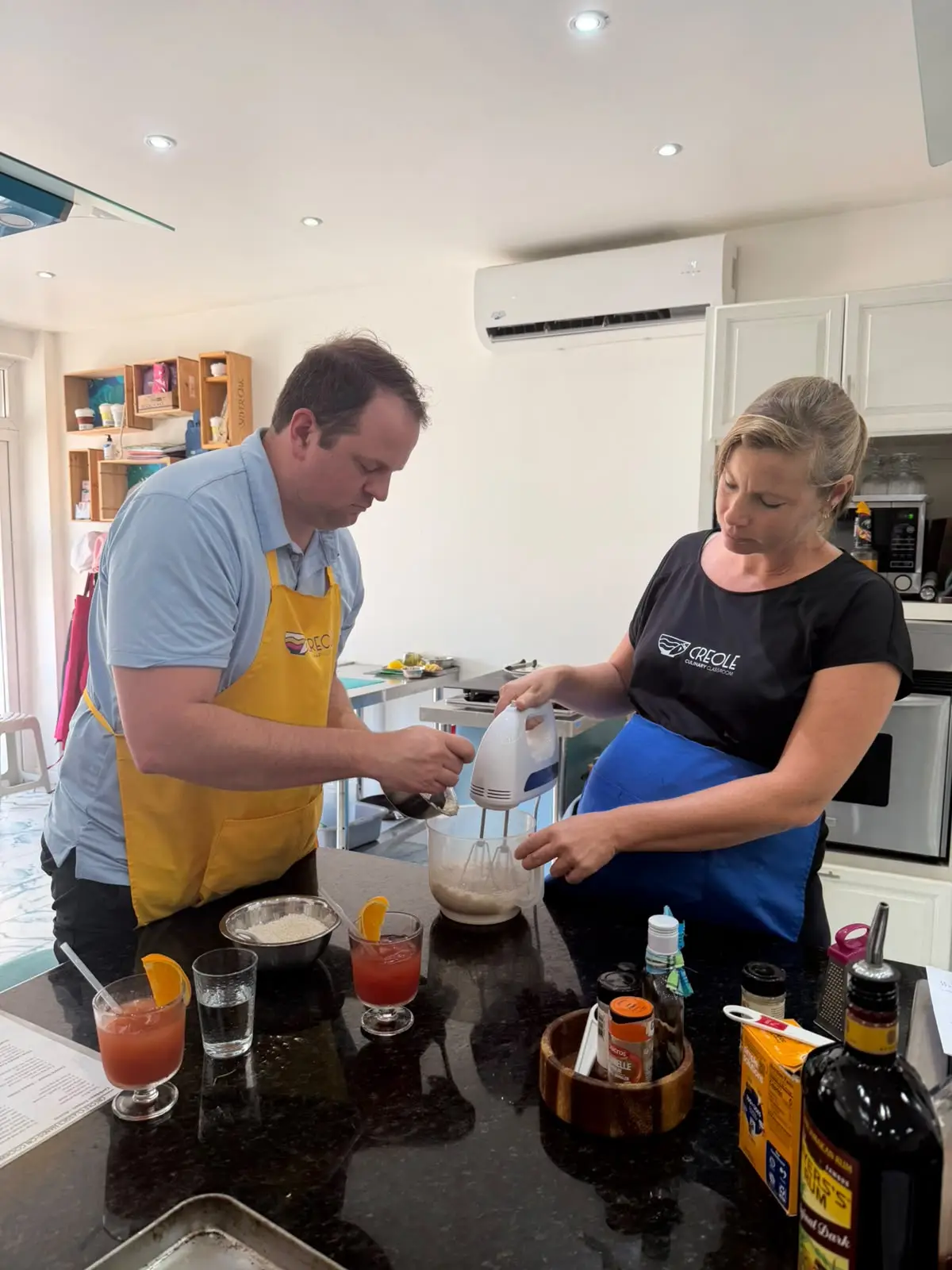 Instructor and participant cooking at creole cooking class