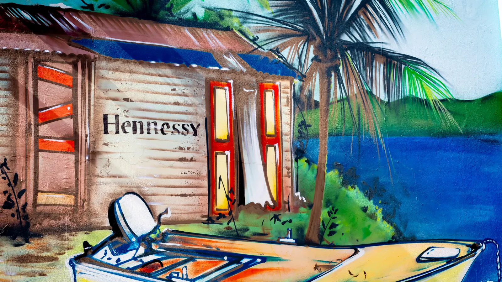 Colorful Philipsburg mural depicts a traditional Caribbean waterfront scene.